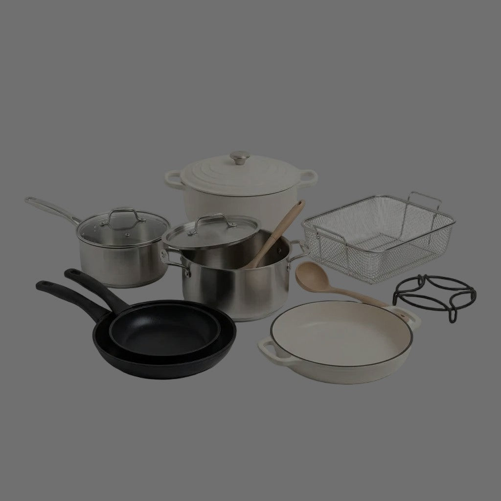 Stainless steel pots with glass lids, black non-stick frying pans, cream enamel casserole and braiser, wire frying basket, wooden spoon and black metal trivet