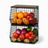 Two stacked black wire baskets with wooden tops holding oranges, apples, onions, tomatoes, peppers and potatoes