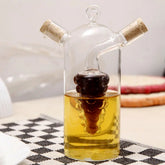 2-in-1 glass oil and vinegar dispenser on a checkered placemat