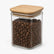 Square glass storage jar with bamboo lid filled with coffee beans