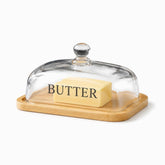 Rectangular bamboo board with raised edge and glass dome lettered BUTTER over a butter block