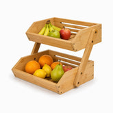 2-tier bamboo fruit basket with bananas, apples, oranges, lemons and a pear, slotted walls and slatted base