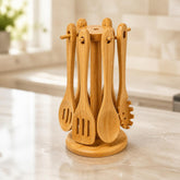 Bamboo utensil carousel stand with 6 hanging utensils on a marble kitchen counter