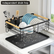 Black dish rack lifted off its separate drip tray by a kitchen sink