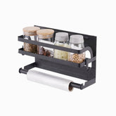 Black magnetic rack with 4 glass jars of spices and a roll on the bar below