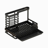 Empty black metal sink caddy with wire brush holder, towel bar, slatted sponge rack and drip tray