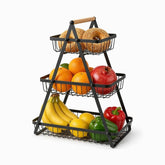 3-tier black metal triangle basket stand with wooden handle holding sesame ka'ak, oranges, pomegranate, bananas, lemons and peppers