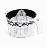 White plexi citrus juicer with clear ribbed reamer, black inner bowl and black-patterned white band on a 400ml measuring jug
