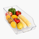 Clear fridge bin holding apples, oranges, lemons, tomatoes, green pepper and corn
