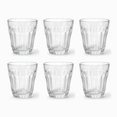 Set of 6 clear flared paneled tea glasses with heavy faceted base arranged in 2 rows