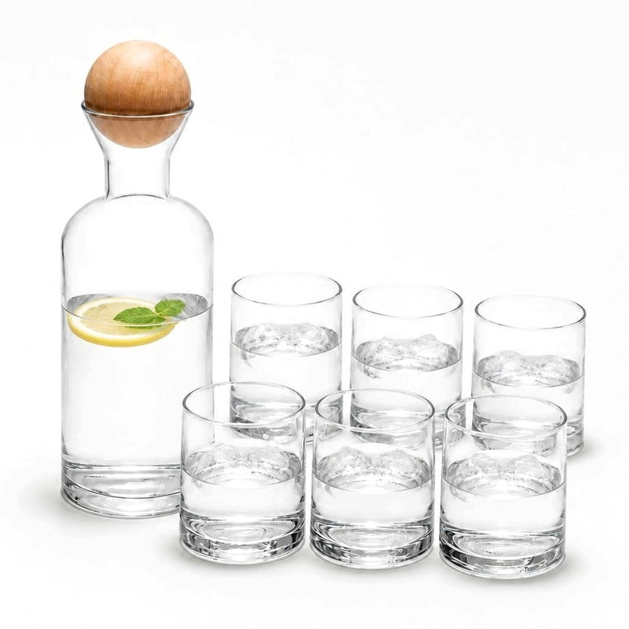 Clear glass carafe with wooden ball stopper and 6 tumblers with water, lemon and ice