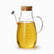 Tall glass oil dispenser with bamboo lid, capped spout and measurement marks to 800ml, filled with olive oil