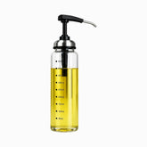 Clear glass pump dispenser with olive oil, black press pump, steel spout and marks up to 450ml