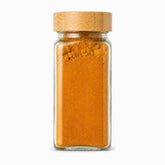 Square glass spice jar 120ml with bamboo lid filled with turmeric