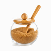 Glass Sugar Jar with Bamboo Lid & Spoon filled with brown sugar, bamboo ball knob lid