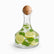 Clear glass carafe with bamboo ball lid filled with lemon slices, mint leaves and ice water