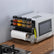 Magnetic rack on the side of a microwave with spice jars, paper towels and hanging tools