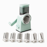 Mint green rotary vegetable slicer with crank handle and 6 drums: 2 shredders, 2 graters and 2 slicers