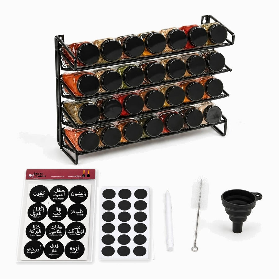 Black metal 4-tier spice rack with 28 glass jars of colorful spices and black lids, with black Arabic and English spice labels, blank labels, white chalk pen, cleaning brush and black silicone funnel