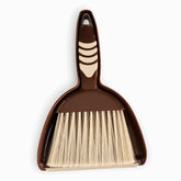 Brown mini dustpan with nested hand brush, cream rubber grip pads and cream bristles, top view