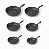 Six Phoenix granite frying pans in sizes 20, 22, 24, 26, 28 and 30 cm lined up from largest to smallest