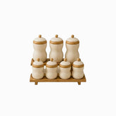 Porcelain Canisters with Bamboo Lids & Rack - 7 cream textured canisters on a bamboo stand