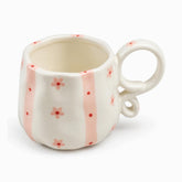 Cream ceramic mug with soft pink stripes, red dots and small pink flowers
