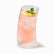 Tall curved ribbed glass with pink rose-water lemonade, ice, lemon slice and mint