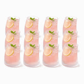 12 short curved ribbed glasses with rose-water lemonade, lemon and mint, in 3 rows