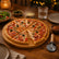 Pizza cut into 8 slices on a round bamboo pizza board with pizza cutter on a cozy dinner table