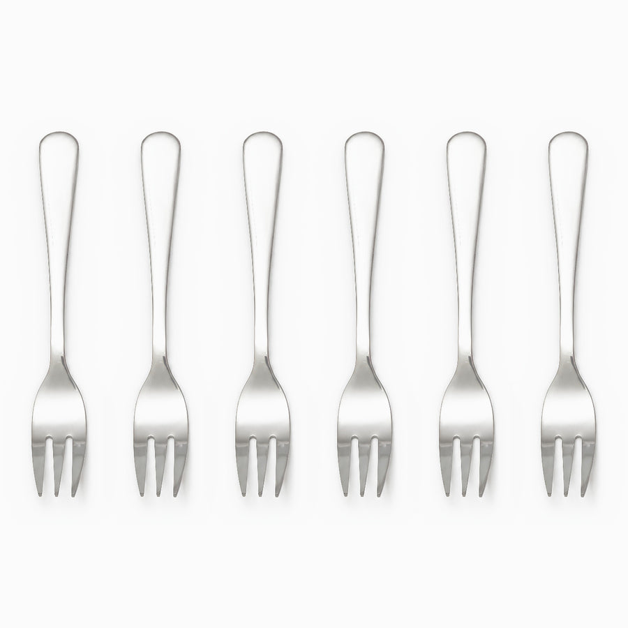 Six mirror-polished stainless steel dessert forks with 3 tines lined up in a row