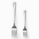 Stainless steel dinner fork and smaller dessert fork with wave handles side by side