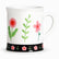 White ceramic mug with pink flowers, green leaf sprigs and a black floral band