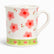 White ceramic mug with pink flowers, red berry sprigs and a lime-green tulip band