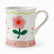 White ceramic mug with a large pink flower, small tulips, green wavy line and a pink floral band