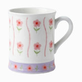 White ceramic mug with pink flowers, wavy pink stripes and a lilac floral band