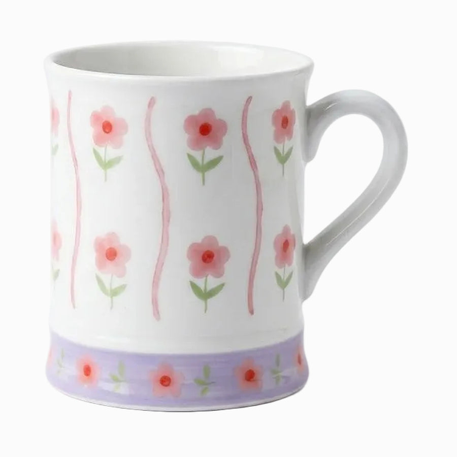 White ceramic mug with pink flowers, wavy pink stripes and a lilac floral band