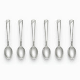 Six stainless steel coffee spoons with engraved wave handles lined up in a row