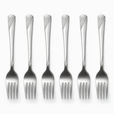 Six stainless steel dessert forks with engraved wave handles lined up in a row