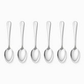 Six mirror-polished stainless steel dessert spoons lined up in a row