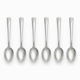 Six stainless steel dessert spoons with engraved wave handles lined up in a row