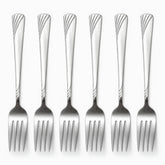 Six stainless steel dinner forks with engraved wave handles lined up in a row