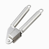 Stainless steel garlic press with square perforated chamber and round hollow handles
