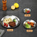 Small, medium and large stainless steel plates on a dark slate table with their diameters of 14, 23 and 30 centimeters marked, holding olives, chicken wings and spaghetti with steak