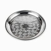 Round stainless steel serving tray with swirl pattern and raised rim