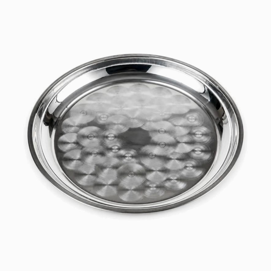 Round stainless steel serving tray with swirl pattern and raised rim