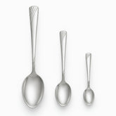 Stainless steel table, dessert and coffee spoons with wave handles side by side to compare sizes