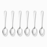 Six mirror-polished stainless steel table spoons lined up in a row