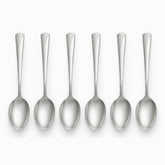 Six stainless steel table spoons with engraved wave handles lined up in a row