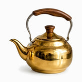 Large wide polished gold teapot with wooden knob and wooden grip handle